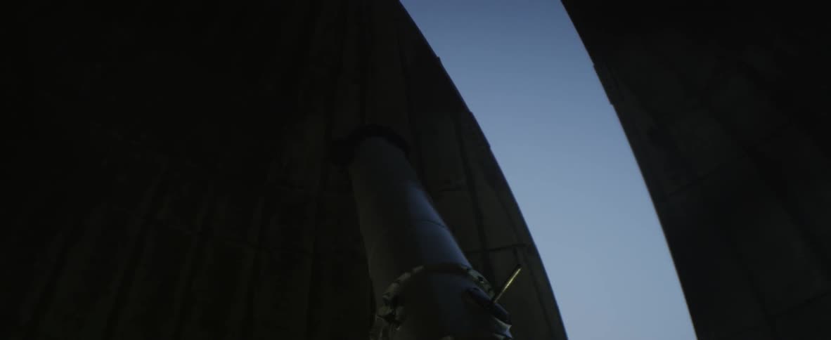Close up of a telescope lining up with an opening to the sky