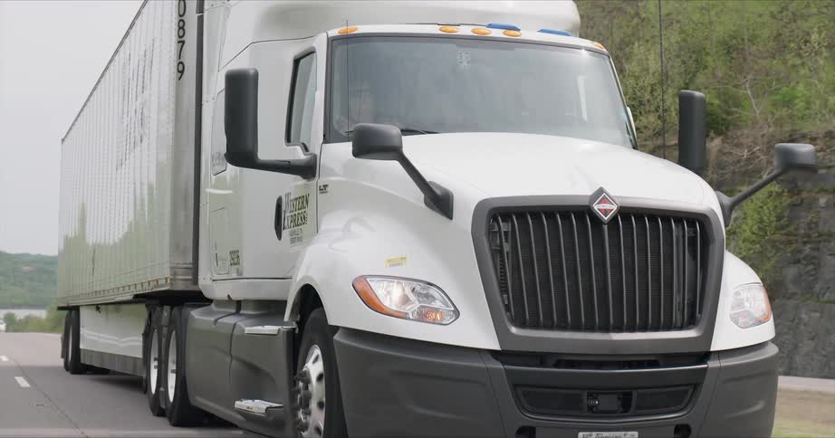 A big rig truck rides on the highway road