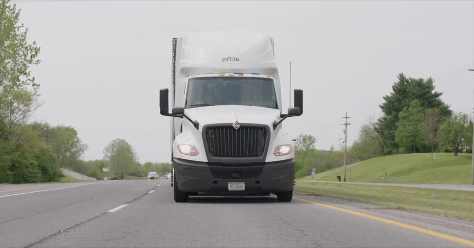 White transport truck travels down the highway