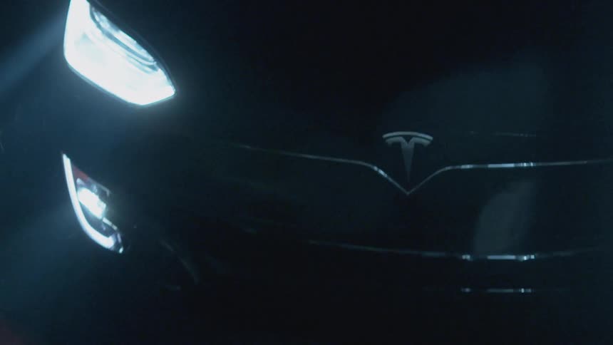 Car drives on a road at night