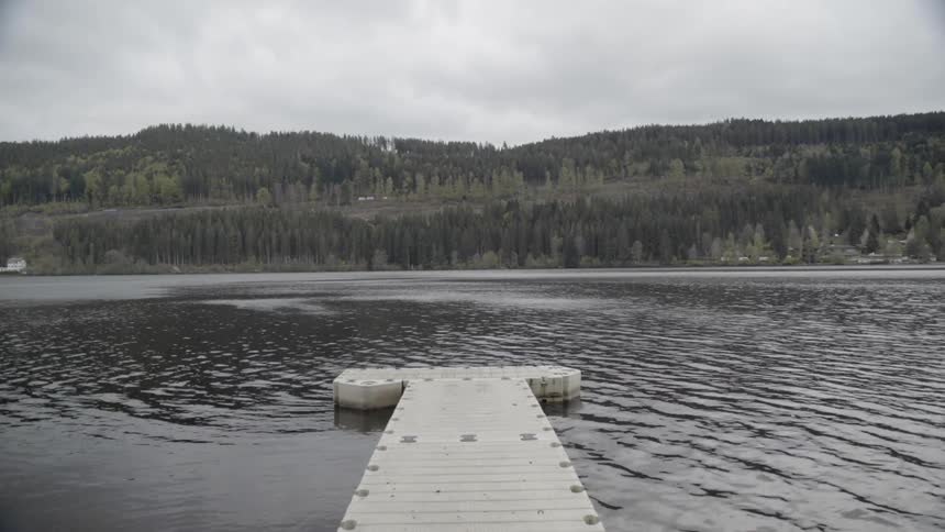 Water flows around a dock on a cloudy day