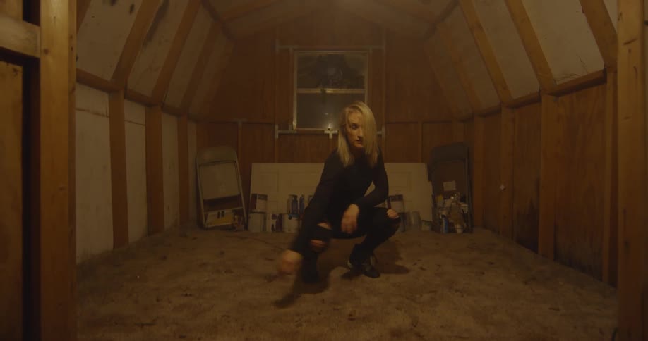 Woman dances in a shed