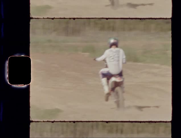 A dirt bike makes a sharp turn on a hill