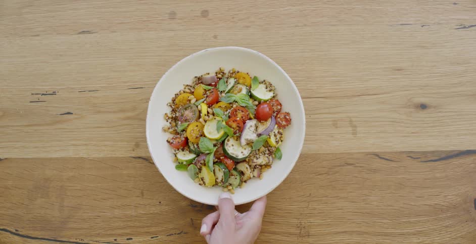 Woman picks up a bowl of food