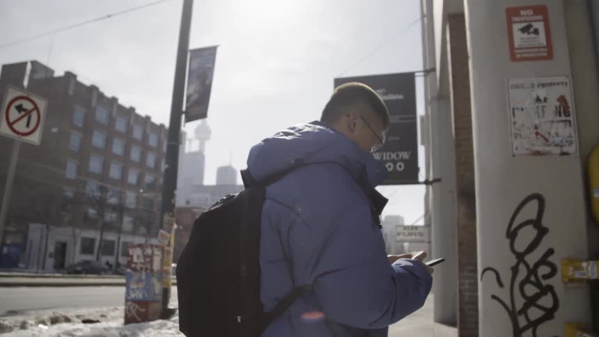 Man walks on a city sidewalk