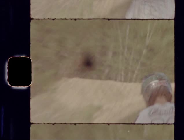 A young man rides a dirt bike on a course