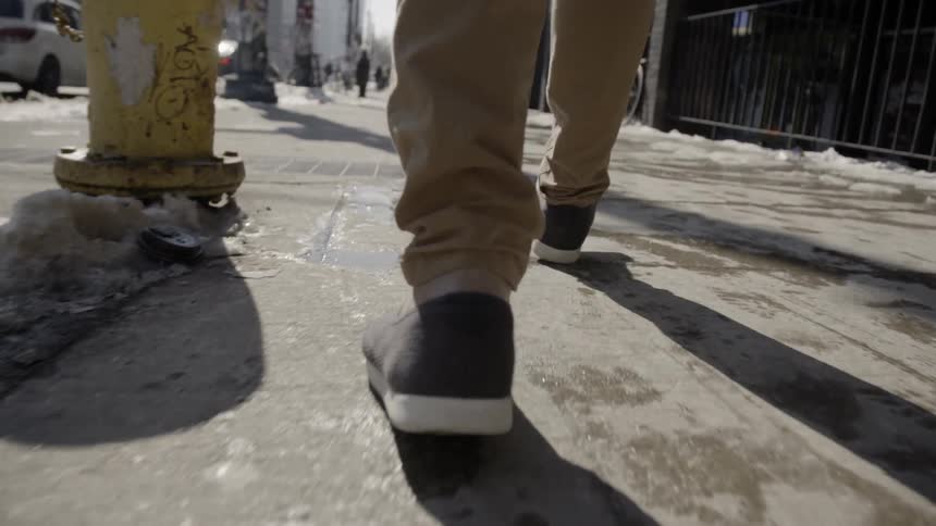 Man walks on a city sidewalk
