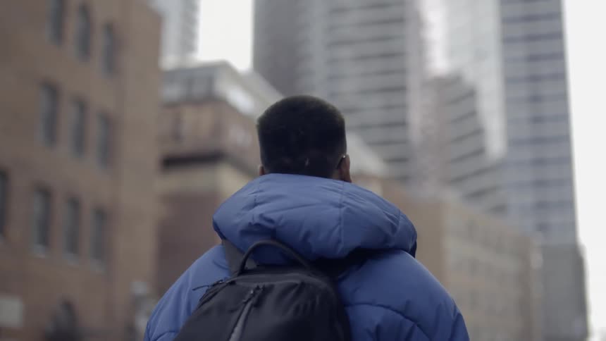 A man walks in the city on a cloudy day