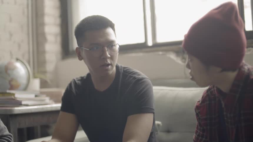 Two people talk on the couch