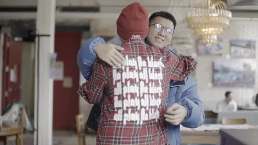 Man and woman hug while greeting each other