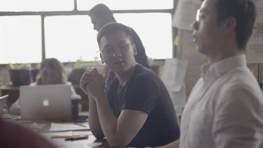 Coworkers talk in an office