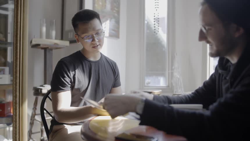 Two people sit down at the table talking