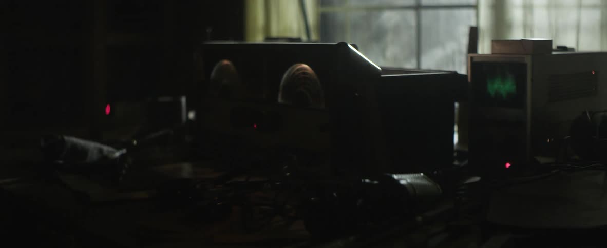 Dark area with an electronic instrument by a window