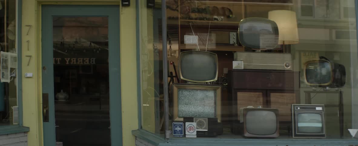 A shop window with multiple televisions displayed