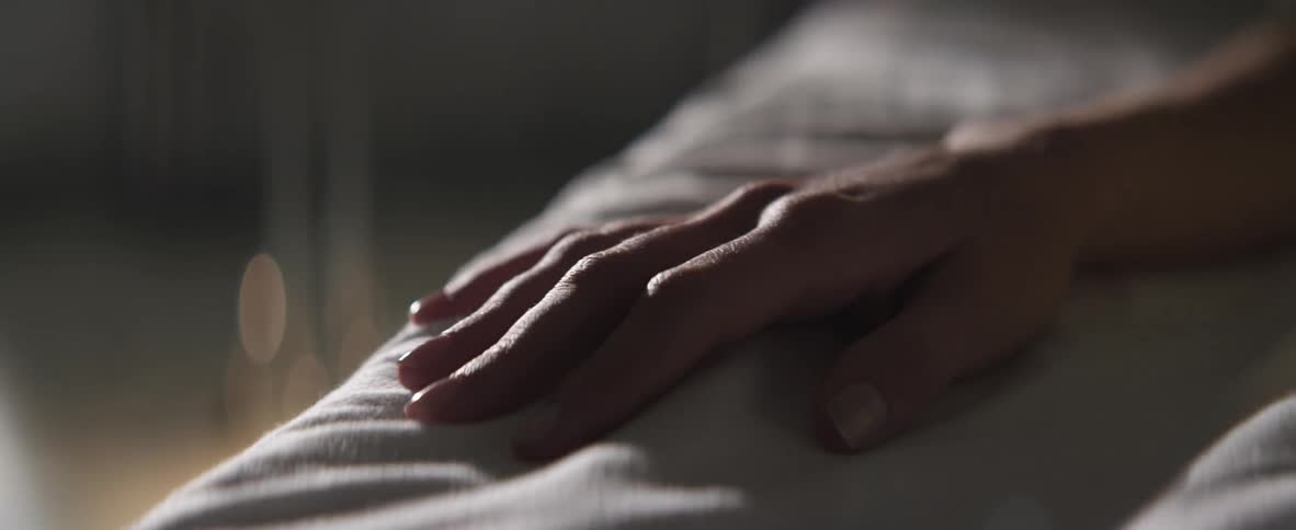 A person is laying down in a bed