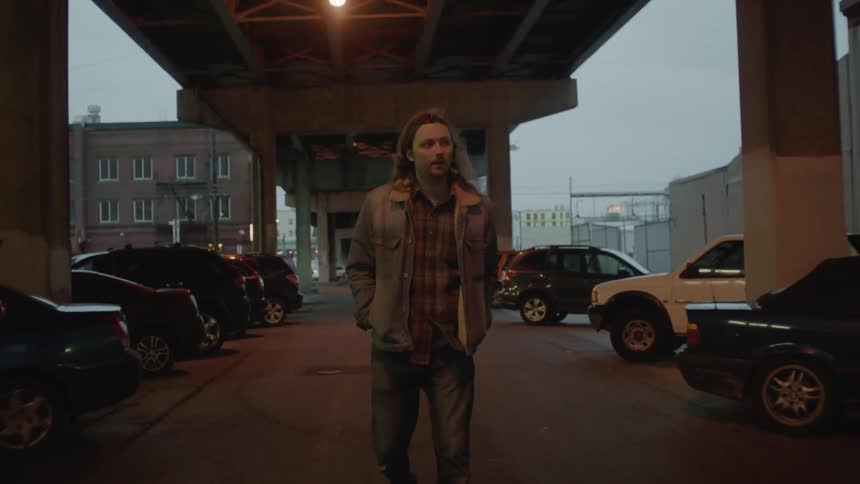 Man walks beneath a city overpass