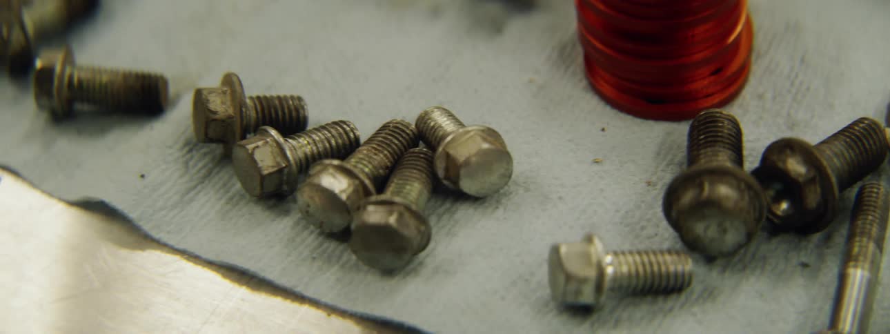 Dirty bolts sit on a table