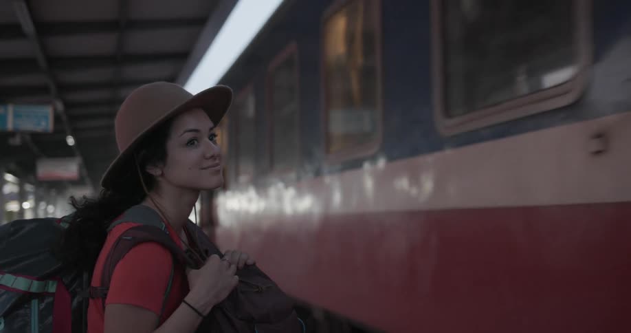 A woman watches the train leave the station