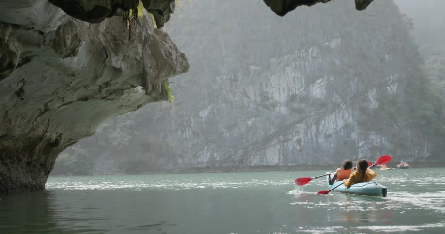 Two women paddle a boat