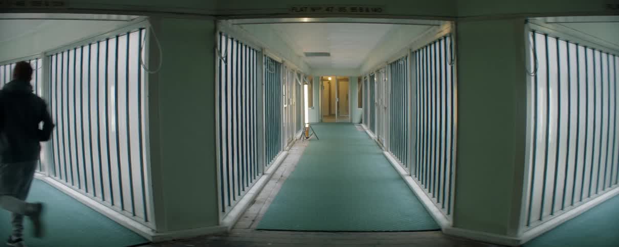A man runs down the long hallway
