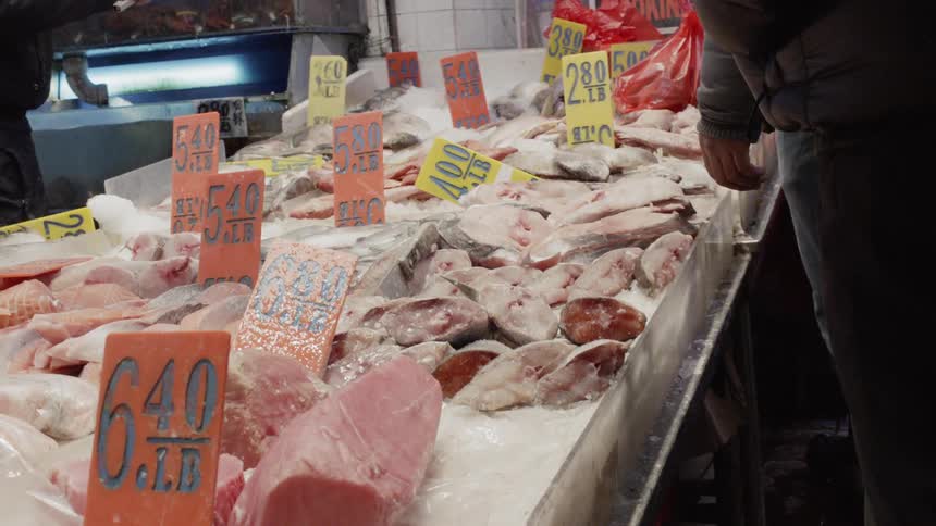 A person is shopping the seafood in the market