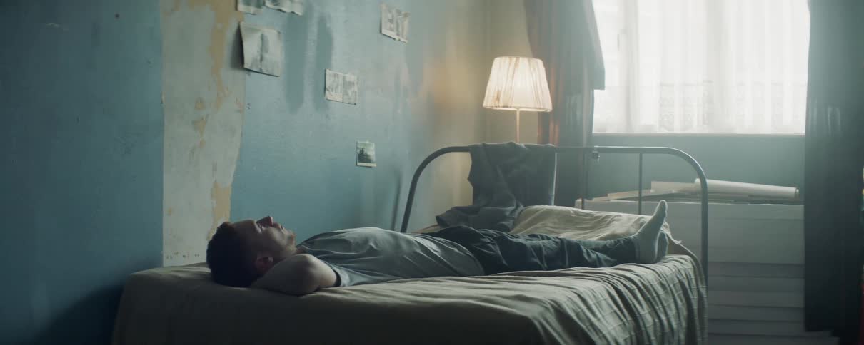 Man lies on a bed