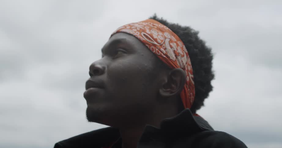 Man is looking at the sky on cloudy day