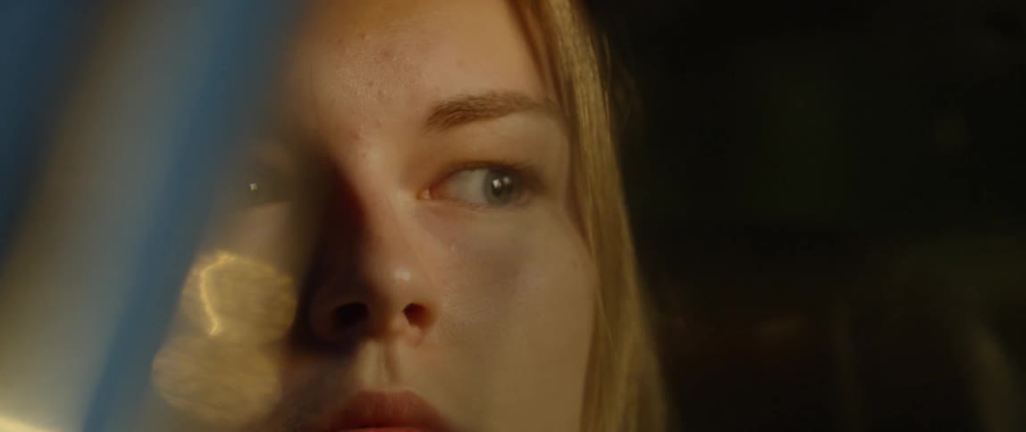 A woman is sitting in car at night