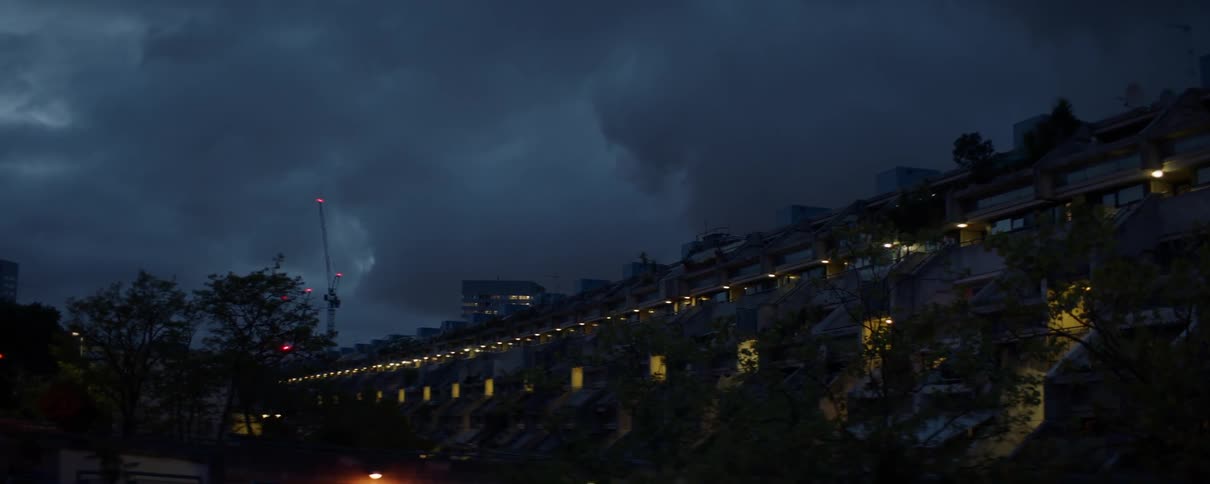 Clouds roll over houses on a cliff
