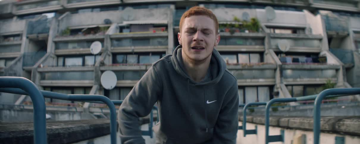 A man checks his watch as he tries to catch his breath after a run