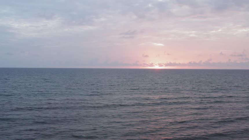 The sun sets over an ocean