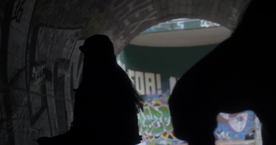 The people are dancing around in the dark tunnel
