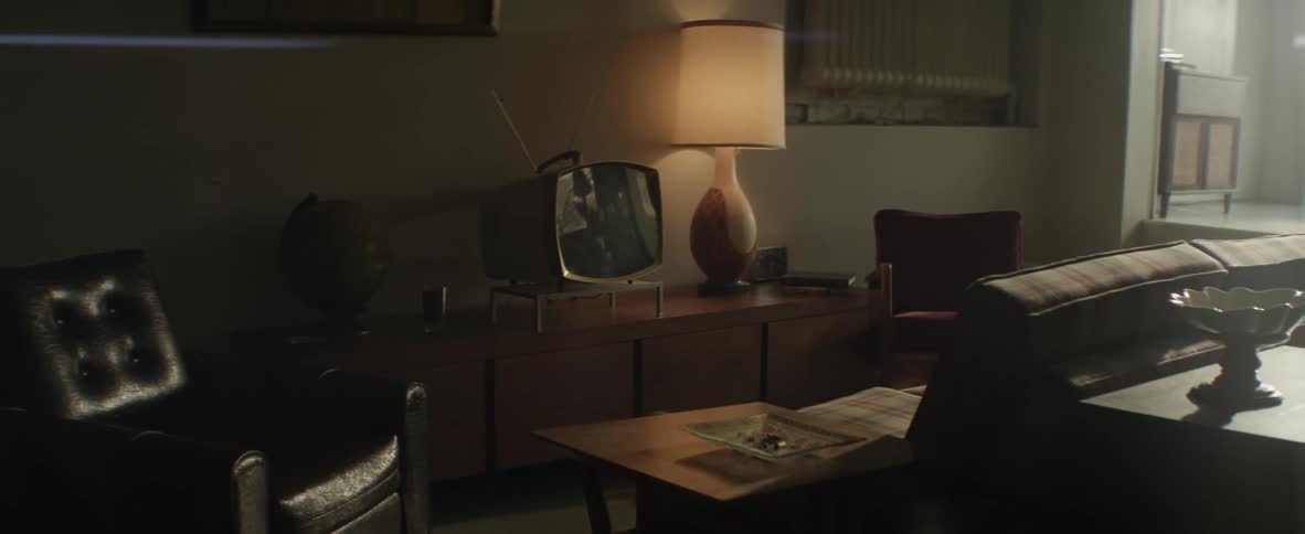 A tv and lamp on a table