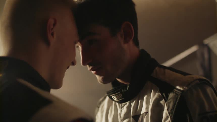 Two men talk face to face