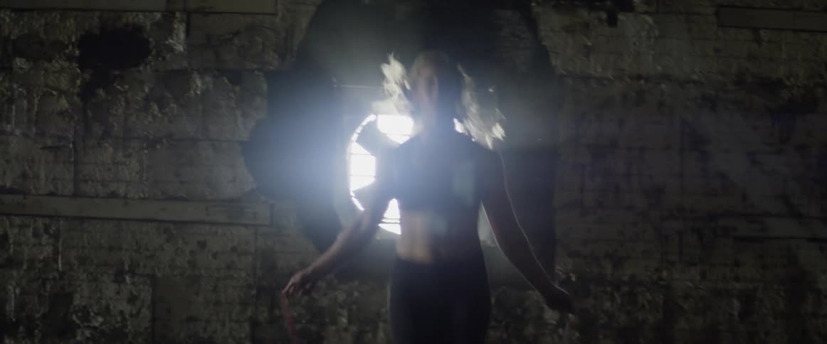 Woman jumps rope in a warehouse