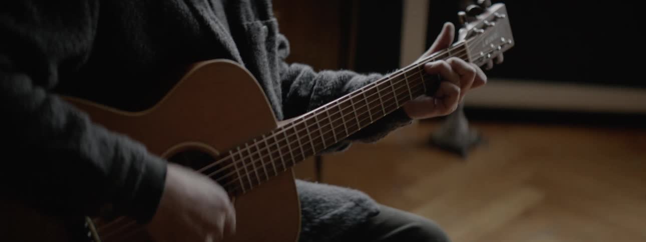 Man playing guitar inside