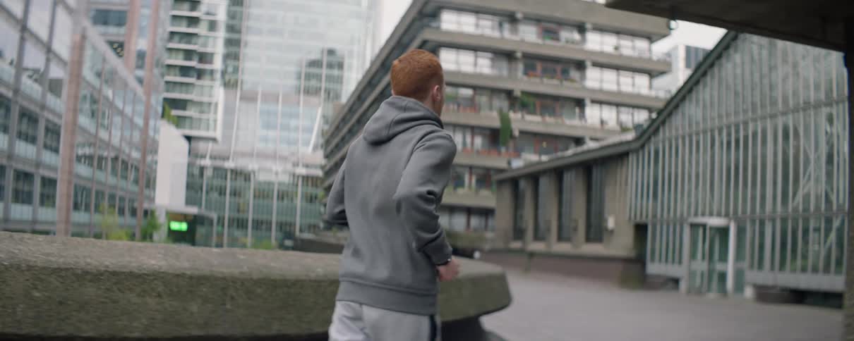 Man jogs on a city sidewalk