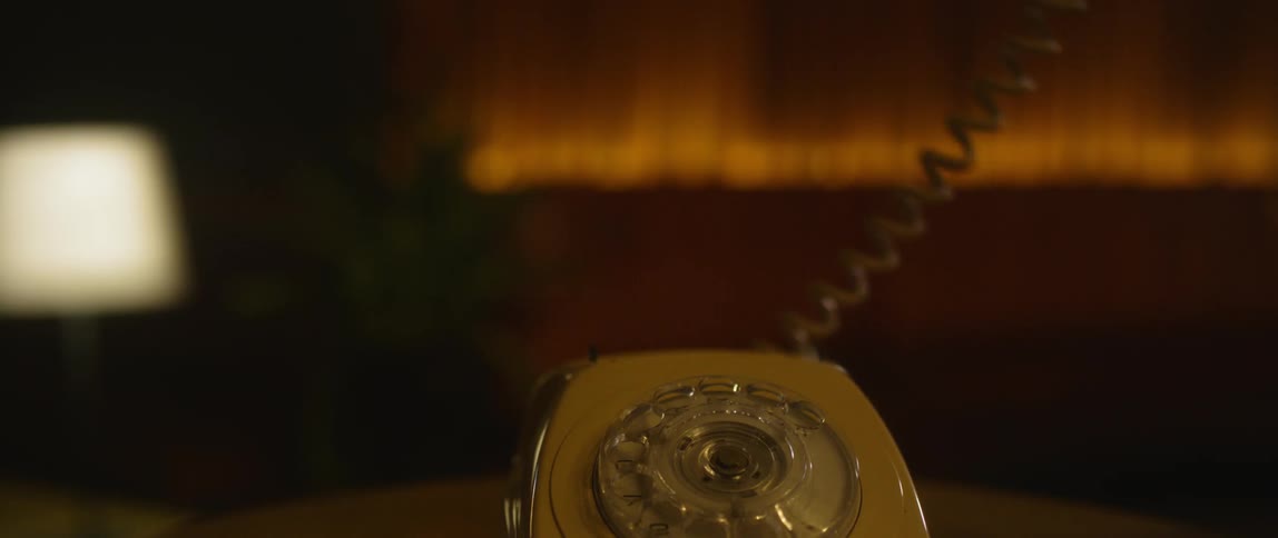 A person answers a phone and hangs up