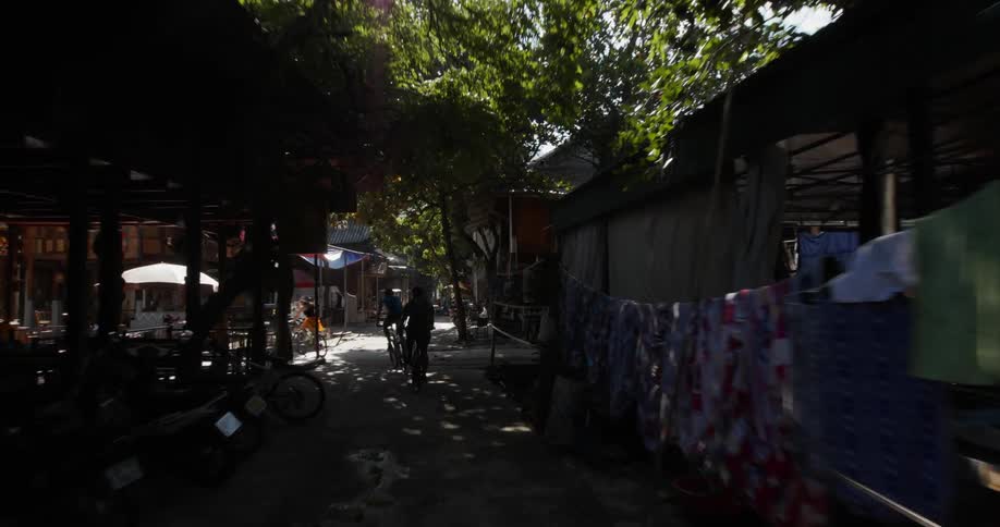 Bicyclists ride through a town