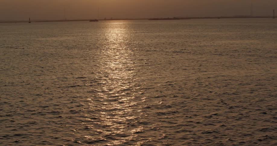 Sunset shining on rippling body of water