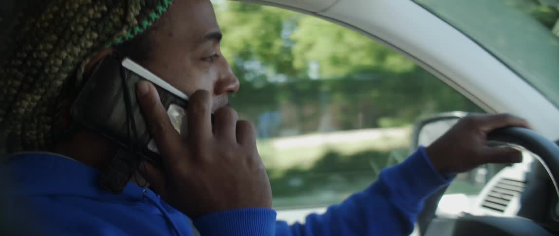 Man talks on the phone while driving