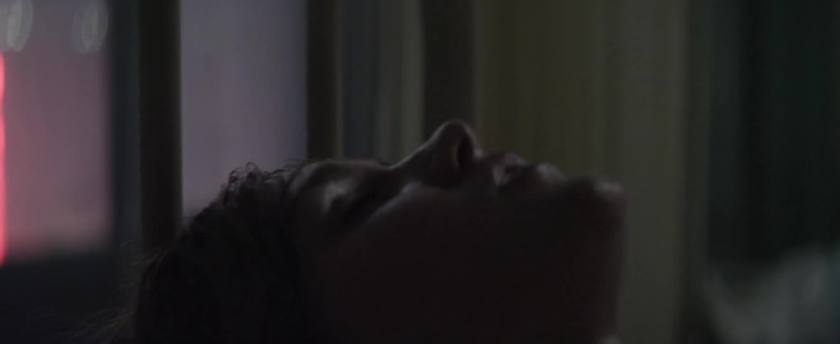 A woman panting and sweating in bed