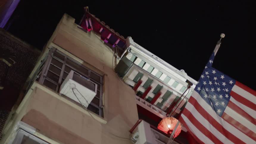Flag hangs of the side of a tall building