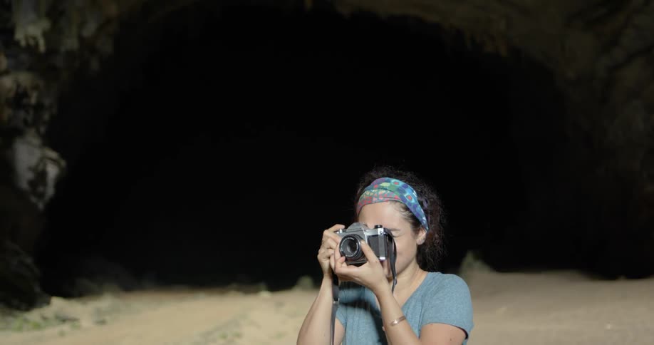 A woman is taking photographs at night
