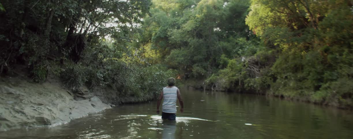 A man wades in the river water