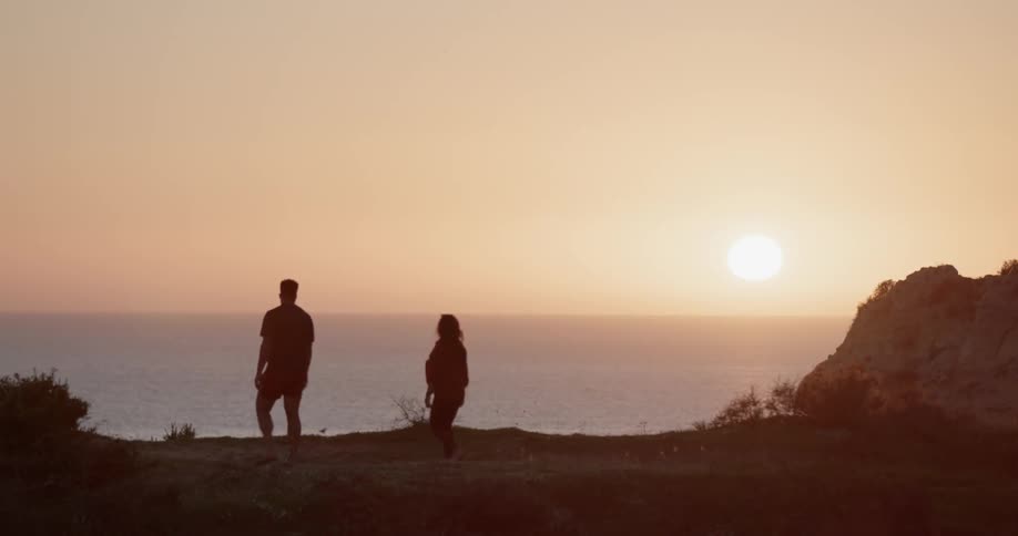 The people walk by the cliff by the ocean