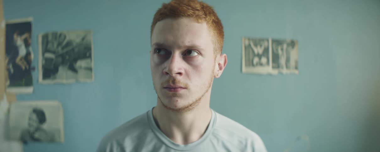 Man looks angry while sitting indoors