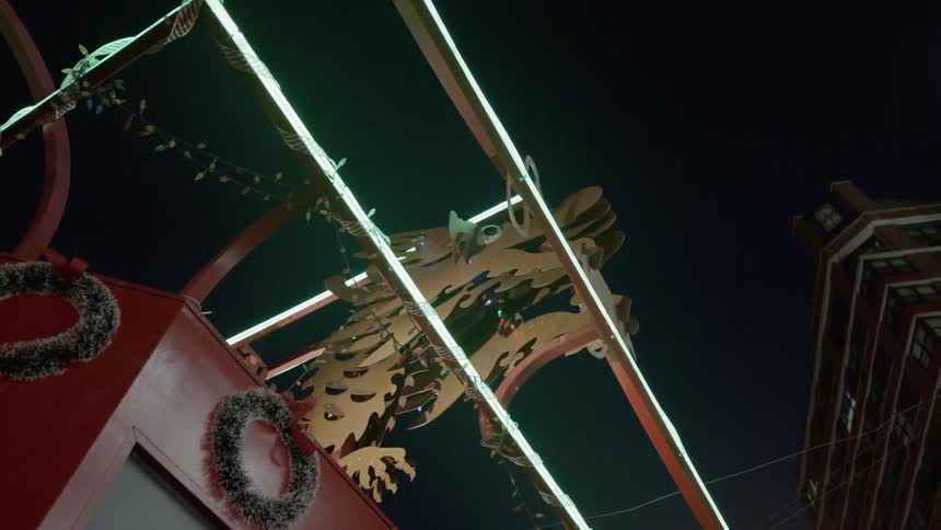 Lights flicker near the gears of a lift bridge