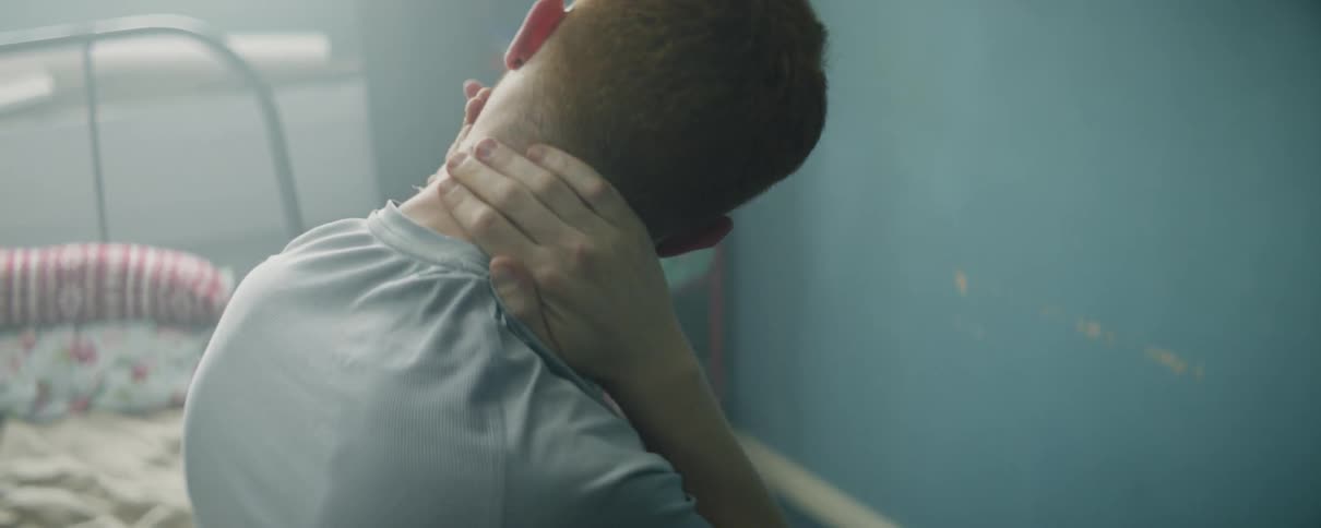 Man sits and cracks his neck