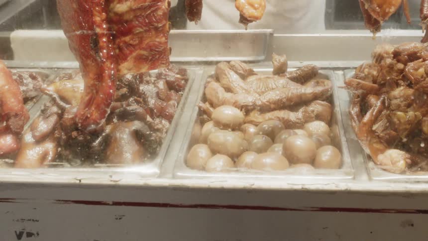 Grocer selecting eggs for customer